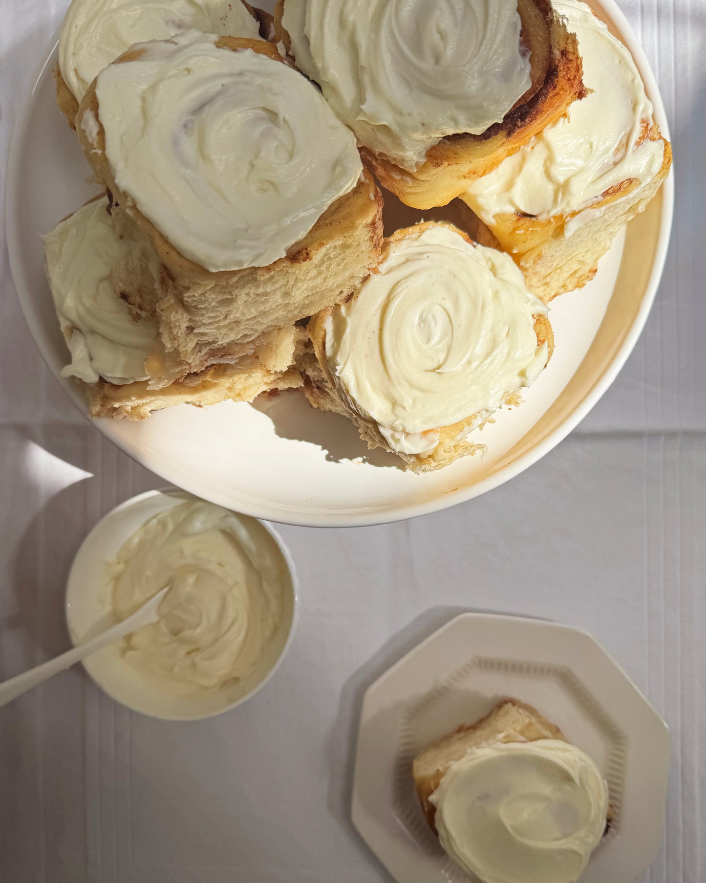 Close up of soft pull apart cinnamon roll with cream cheese icing Sunday Crust