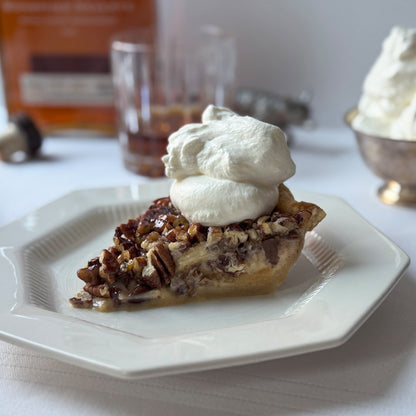 Pecan pie slice with whipped cream and warm bourbon notes baked by Sunday Crust Augusta Georgia