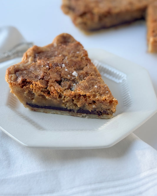 Slice of toasted chocolate oat chess pie with cocoa custard, toasted oats, and an all butter crust