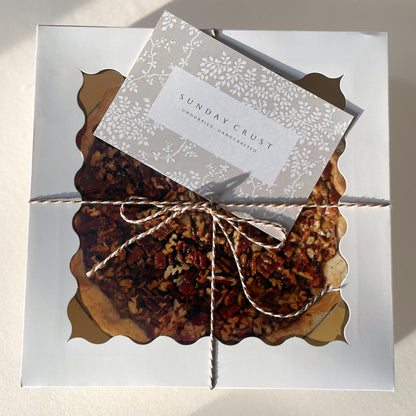 Pecan pie packaged for gifting with Sunday Crust card and ribbon baked in Augusta Georgia