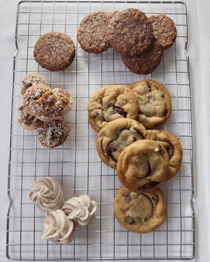 Assorted small batch cookies including chocolate, molasses oat, pecan tarts, and meringue kisses