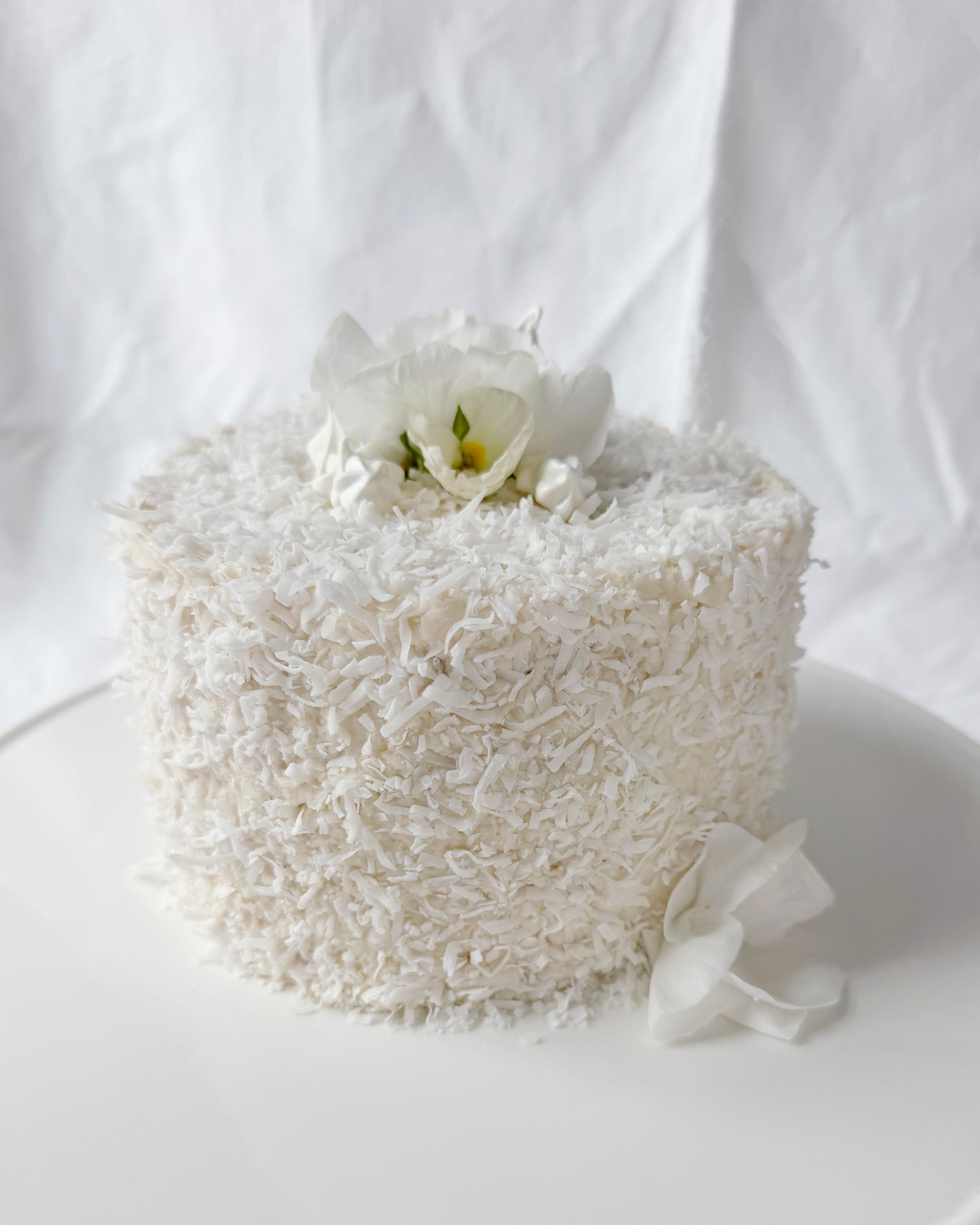 Coconut cake decorated with seasonal spring flowers in Augusta GA