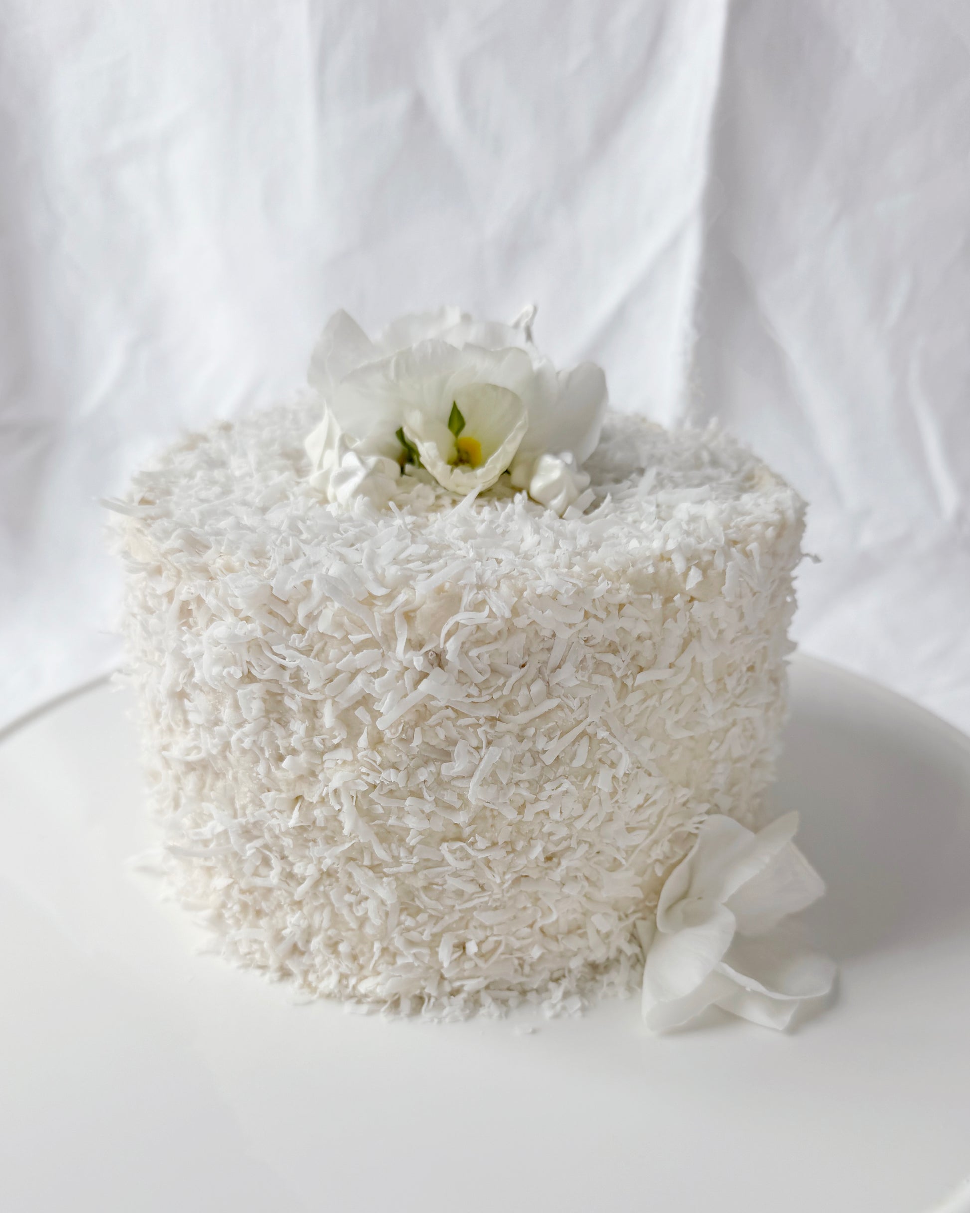 Coconut cake decorated with seasonal spring flowers in Augusta GA