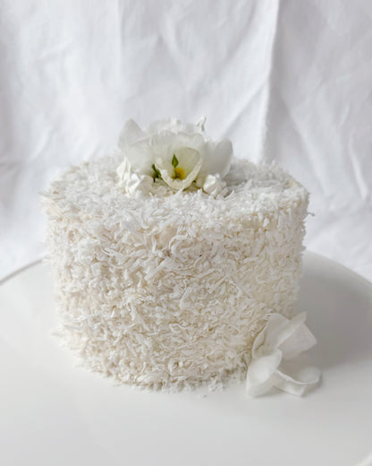 Coconut cake decorated with seasonal spring flowers in Augusta GA