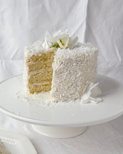 Four layer coconut garden cake with haupia coconut cream and seasonal spring flowers in Augusta Georgia