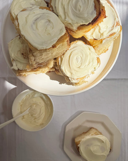 Close up of soft pull apart cinnamon roll with cream cheese icing Sunday Crust